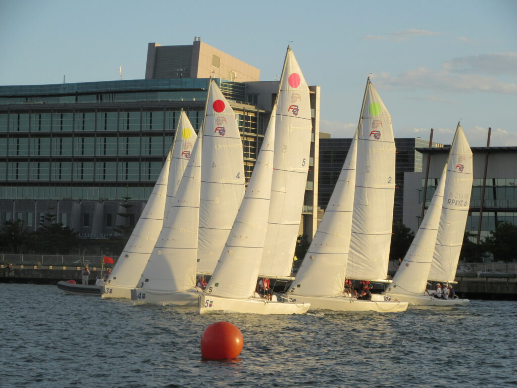 Sailing boats in a race in the twilight
